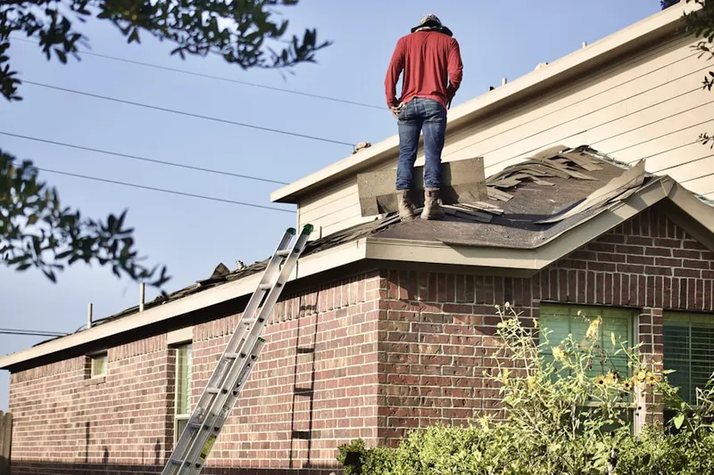 Professional roofer working on a residential roof in Ara